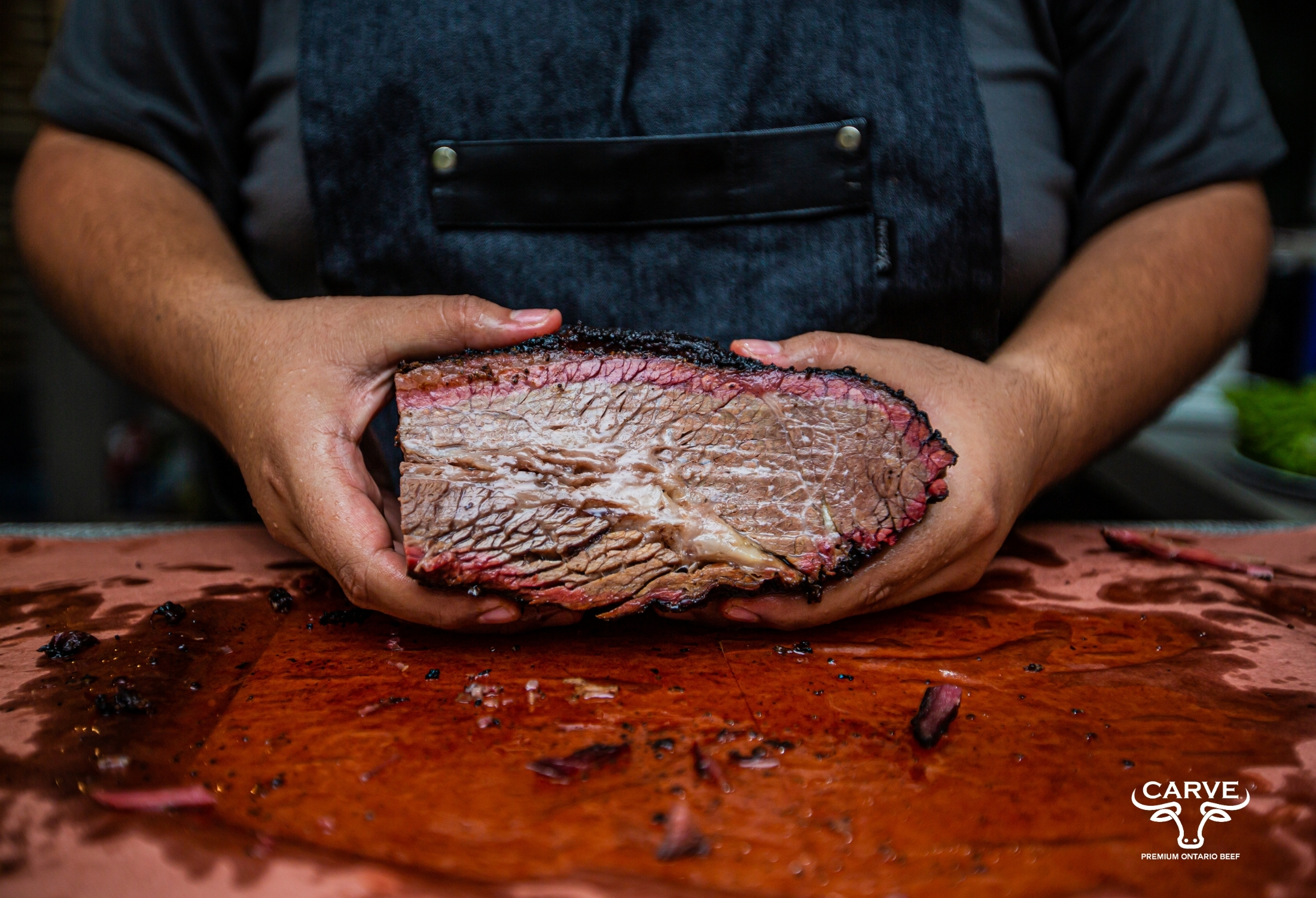 Chef holding cooked brisket Chef holding cooked brisket